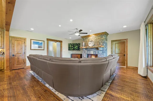 a living room with fireplace furniture and a wooden floor