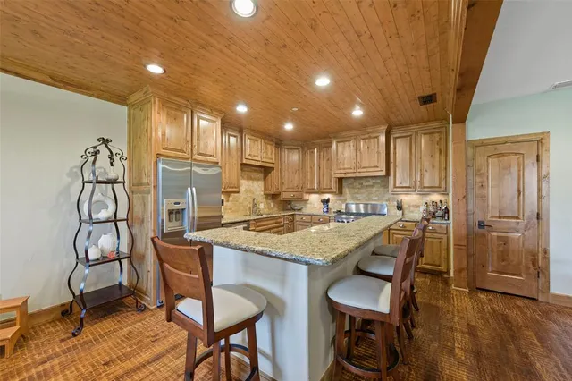 a kitchen with a table chairs refrigerator and cabinets