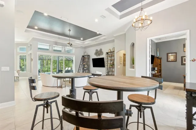 a bathroom with a double vanity sink a large mirror a bathtub and a window
