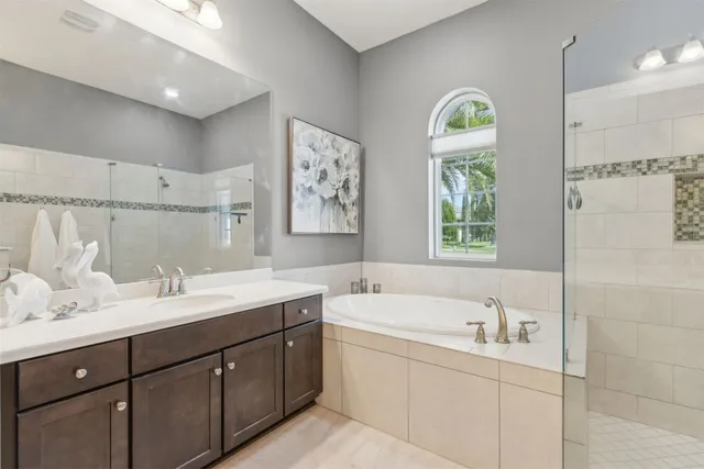 a bathroom with a double vanity sink mirror and toilet