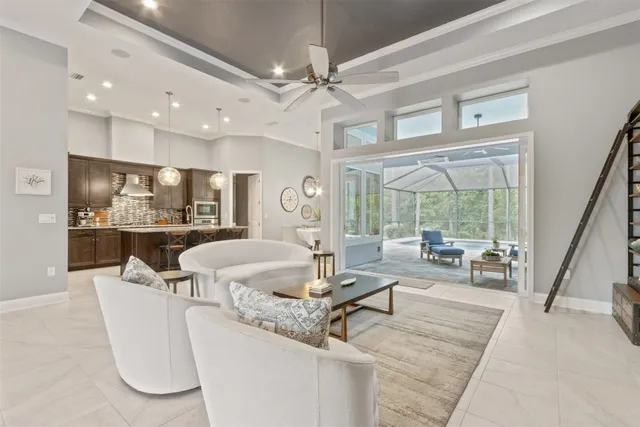 a living room with furniture a flat screen tv and a large window