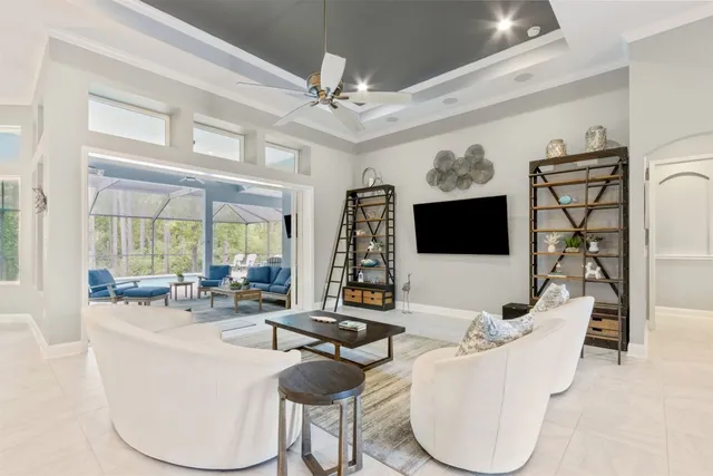 a living room with furniture and a view of kitchen