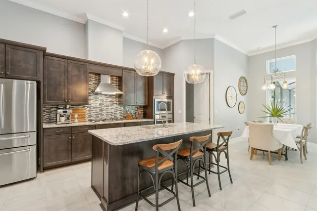 a kitchen with stainless steel appliances granite countertop a sink and a microwave