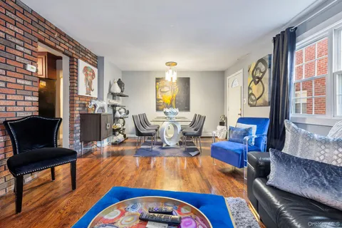 a living room with furniture fireplace and flat screen tv