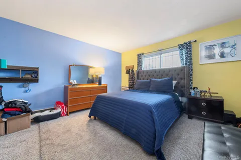 a bedroom with a bed and dresser