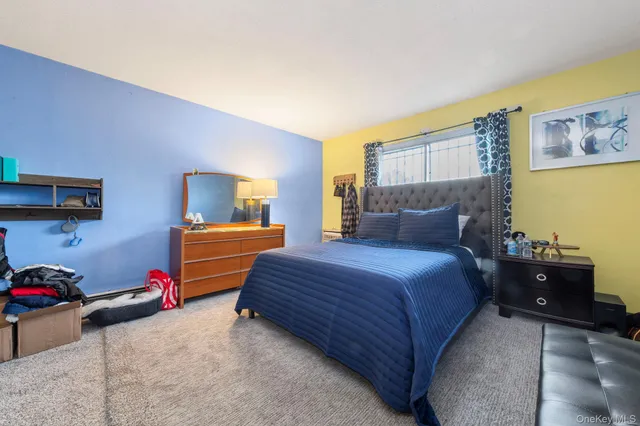 a bedroom with a bed and dresser