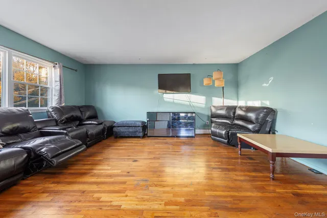 a living room with furniture window and a flat screen tv