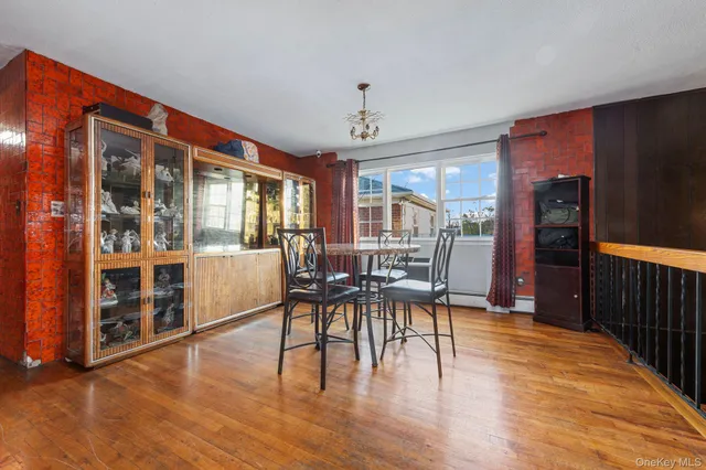 a dining room with furniture entryway and wooden floor