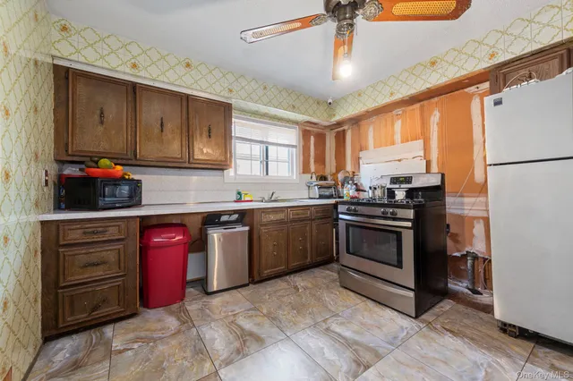 a kitchen with granite countertop a sink stainless steel appliances and cabinets