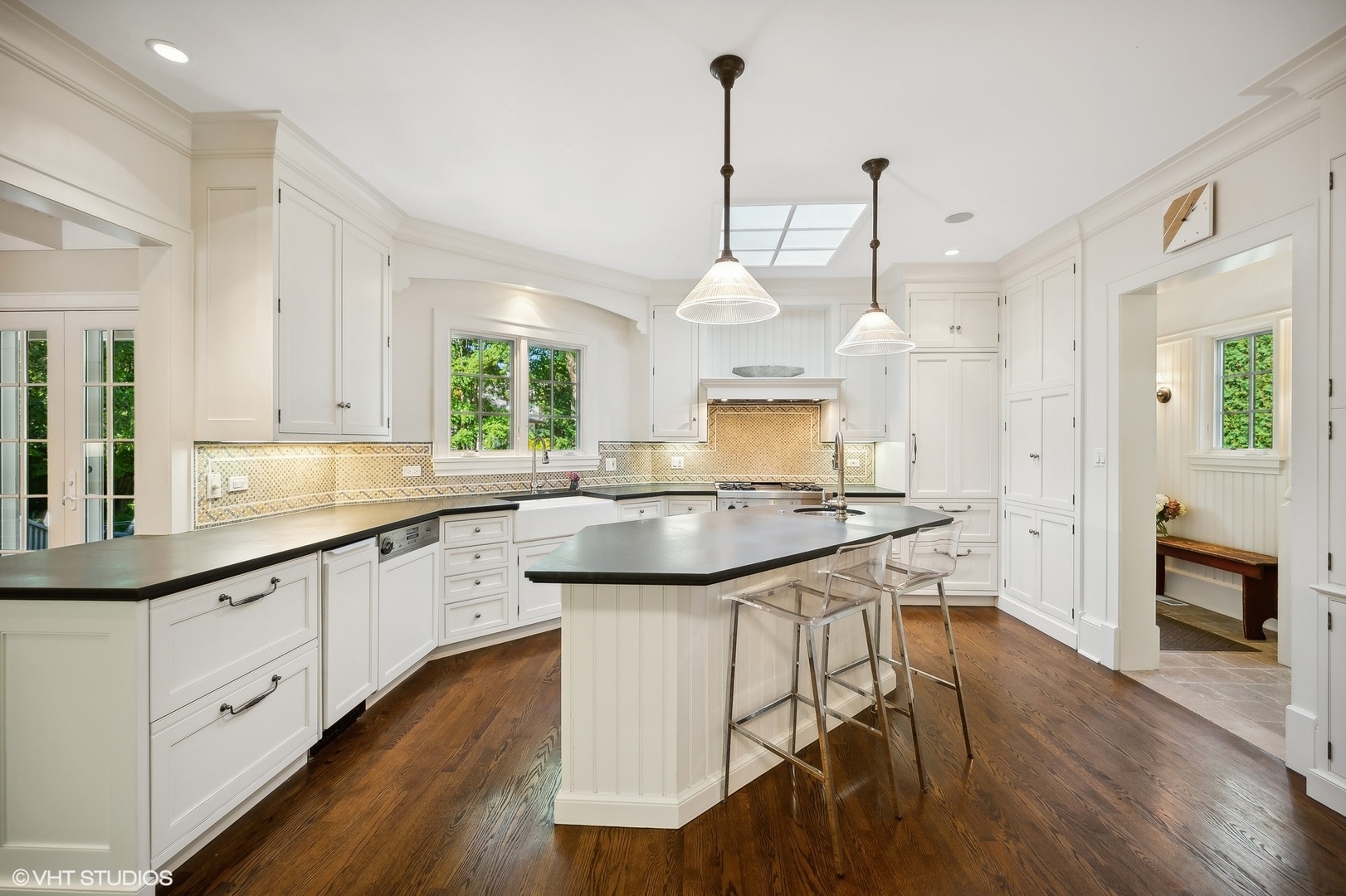 1015 Dinsmore Road Winnetka, IL 60093 - Photo 15 of 46 a kitchen with stainless steel appliances granite countertop wooden floors sink and cabinets
