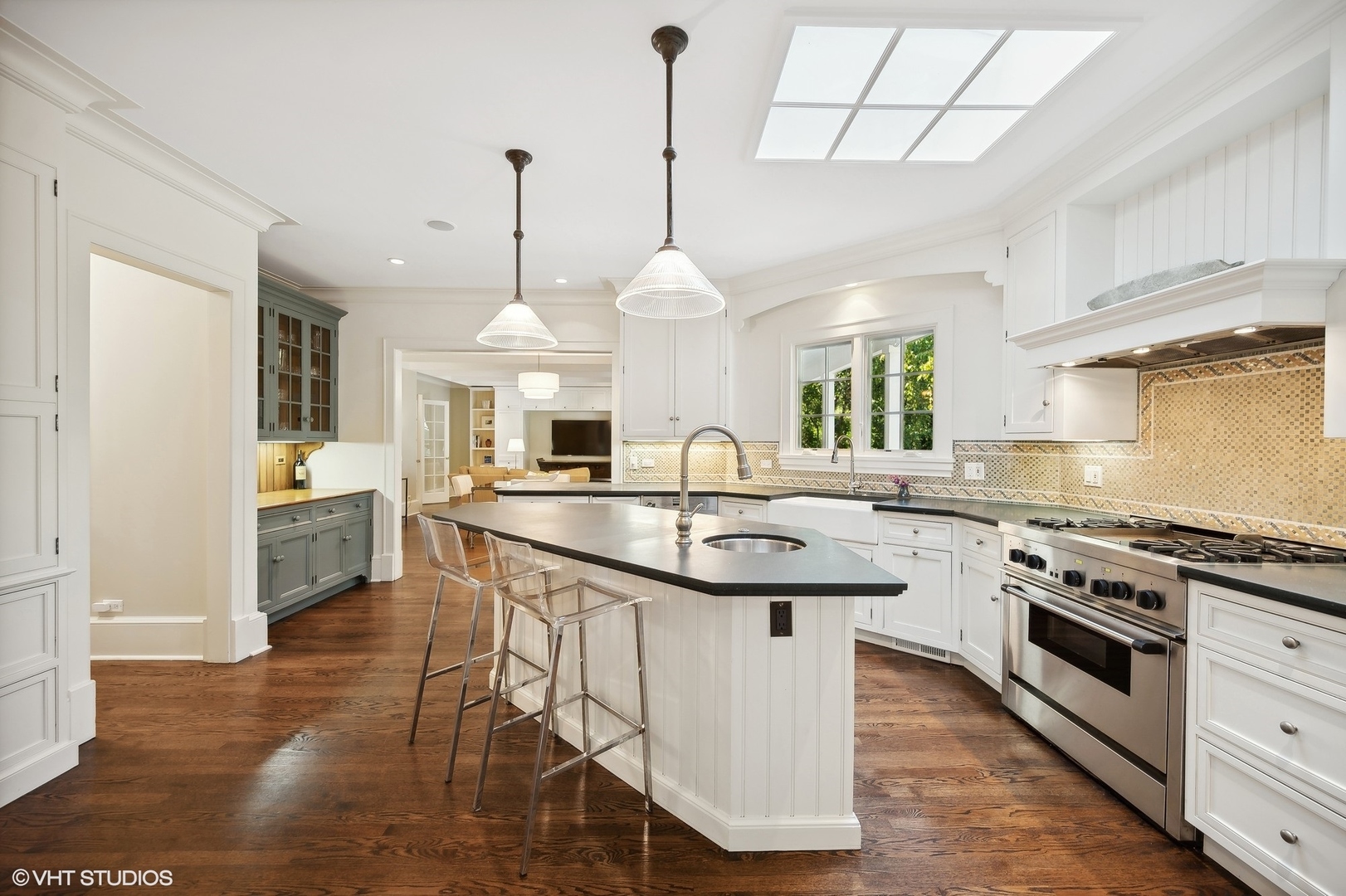 1015 Dinsmore Road Winnetka, IL 60093 - Photo 16 of 46 a kitchen with stainless steel appliances granite countertop a sink a stove and a wooden floors