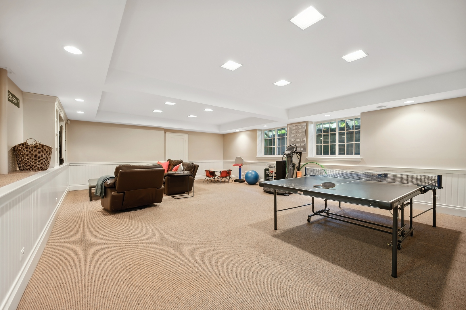 1015 Dinsmore Road Winnetka, IL 60093 - Photo 40 of 46 a living room with furniture a table and potted plants with wooden floor