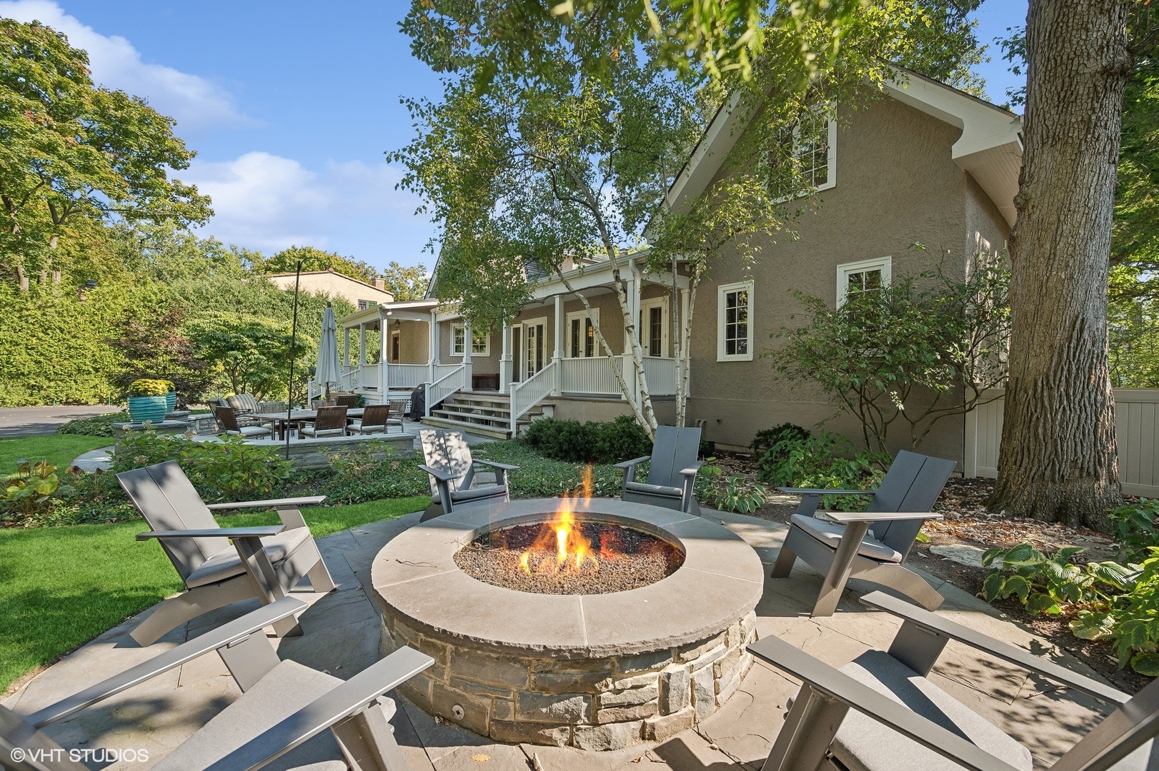 1015 Dinsmore Road Winnetka, IL 60093 - Photo 45 of 46 a view of a patio with table and chairs potted plants and a large tree
