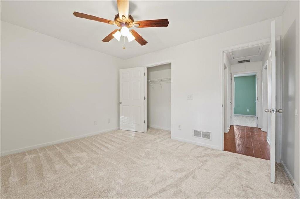 1218 Morgans Run Monroe, GA 30656 - Photo 24 of 39 an empty room with closet and a chandelier fan
