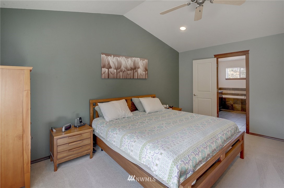 3424 189th Place Southeast Bothell, WA 98012 - Photo 14 of 16 a bedroom with a bed and a chandelier