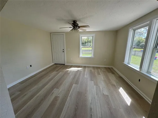 wooden floor in an empty room with a window