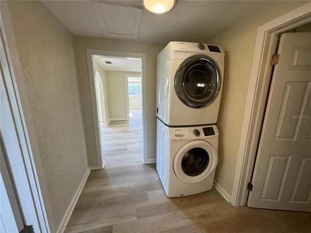 a view of a hallway with washer and dryer