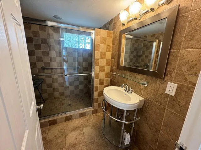 a bathroom with a sink toilet and shower