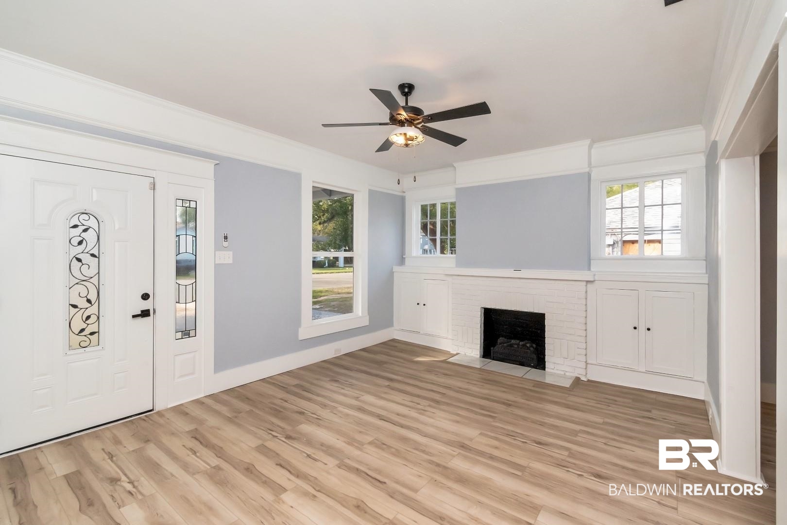 555 Michigan Avenue Mobile, AL 36604 - Photo 3 of 28 Unfurnished living room featuring ornamental molding, light wood-type flooring, a fireplace, and ceiling fan