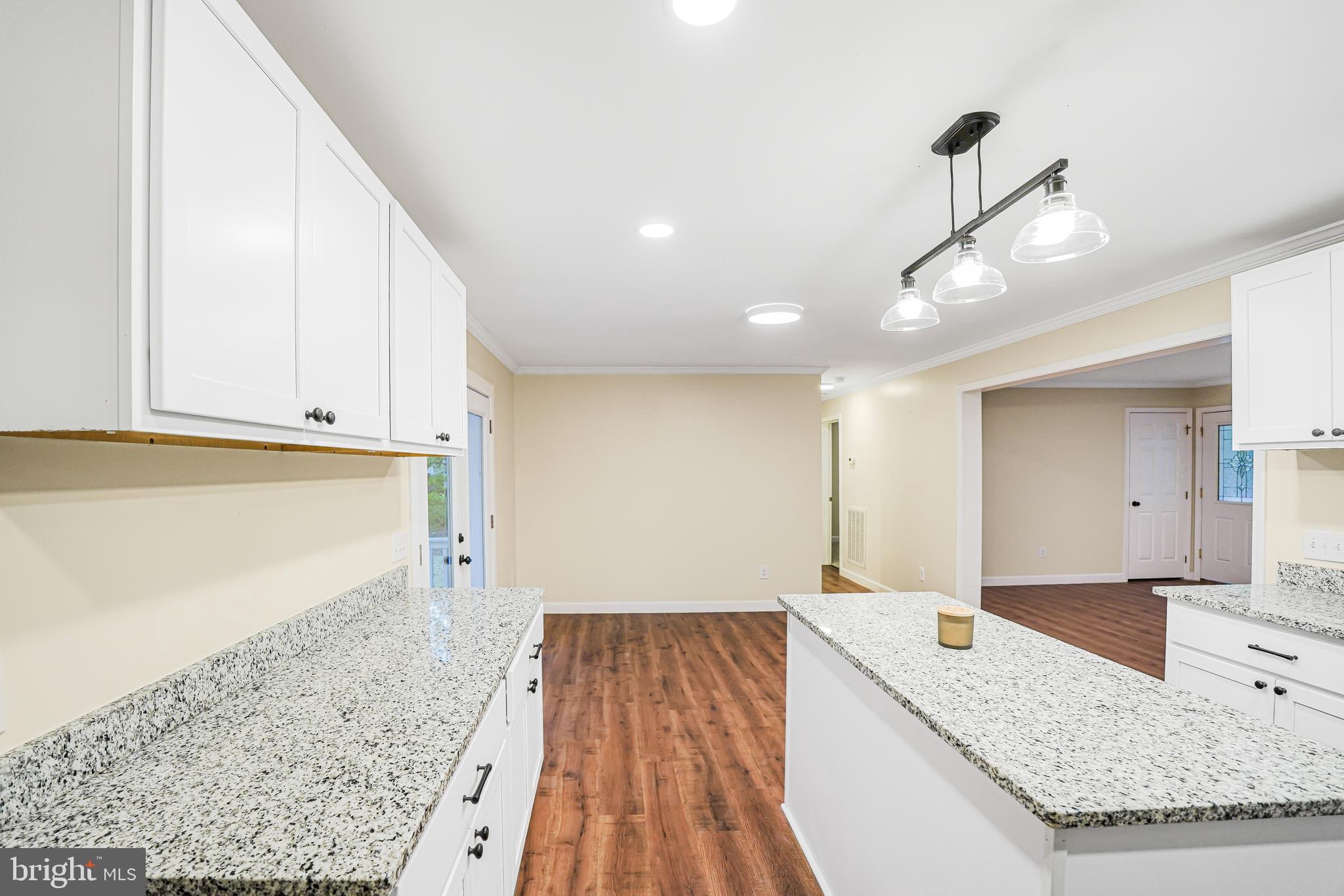 767 Loving Road Zion Crossroads, VA 22942 - Photo 9 of 33 a open kitchen with kitchen island a sink stove and wooden floors