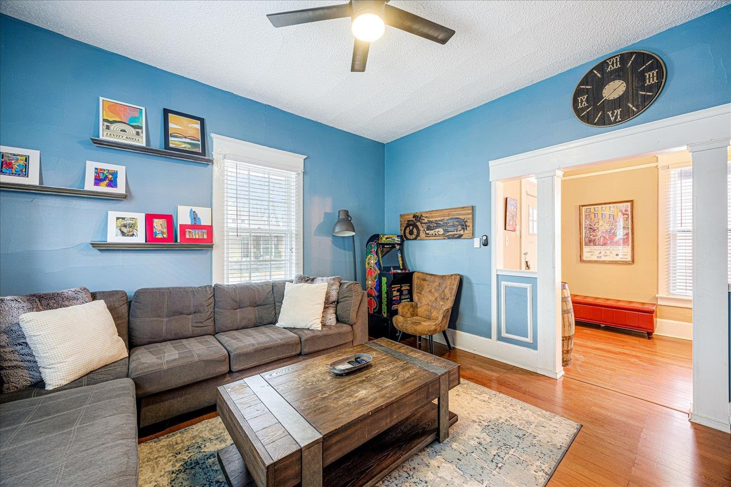 a living room with furniture and a wooden floor