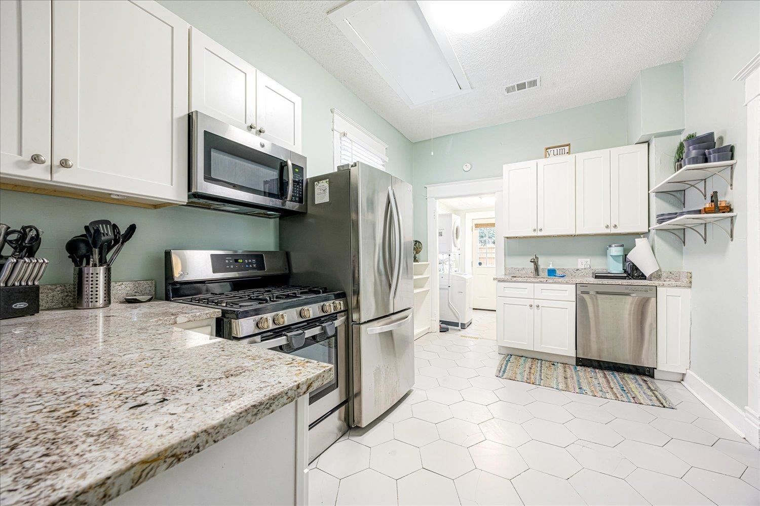 977 Philadelphia Street Memphis, TN 38104 - Photo 8 of 14 a kitchen with granite countertop a sink stove and refrigerator