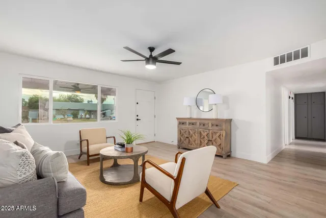 a living room with furniture a window and a chandelier