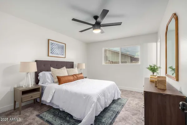 a bedroom with bed and window