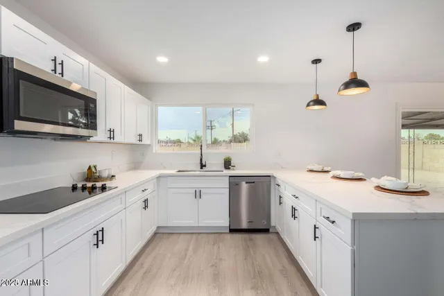 a kitchen with a sink stove and microwave