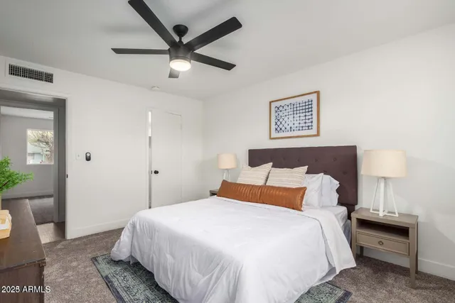 a bedroom with a bed and a lamp on table