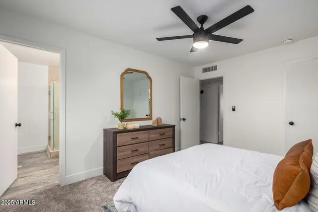 a bedroom with a bed and a dresser