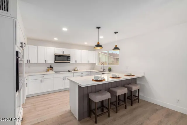 a kitchen with appliances a sink and cabinets