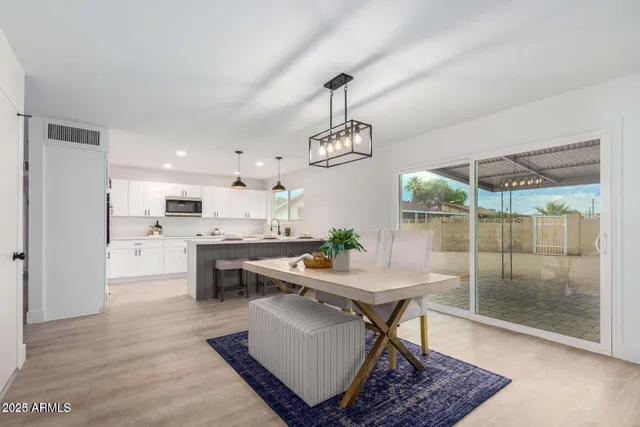 a living room with dining table furniture and a chandelier