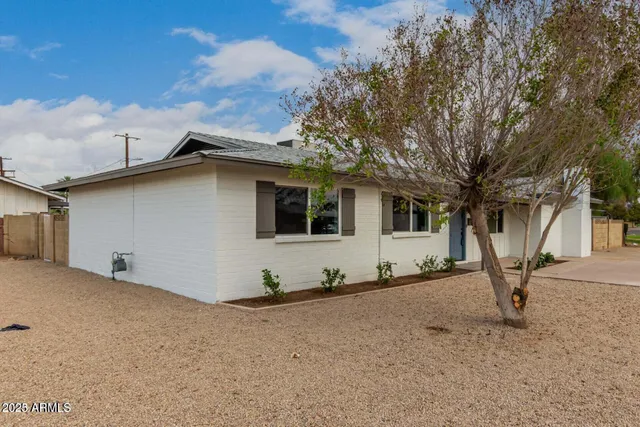 a view of a house with a yard covered in snow