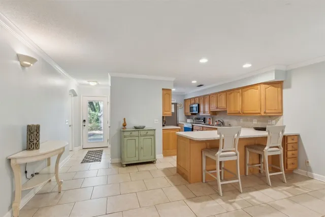 a kitchen with stainless steel appliances kitchen island granite countertop a sink and cabinets