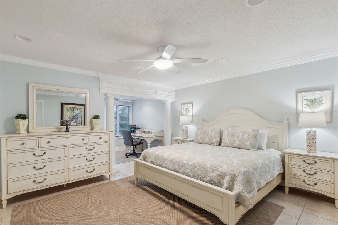 3323 Sea Marsh Road, Unit 3323 Fernandina Beach, FL 32034 - Photo 14 of 48 a bedroom with a large bed and a chandelier