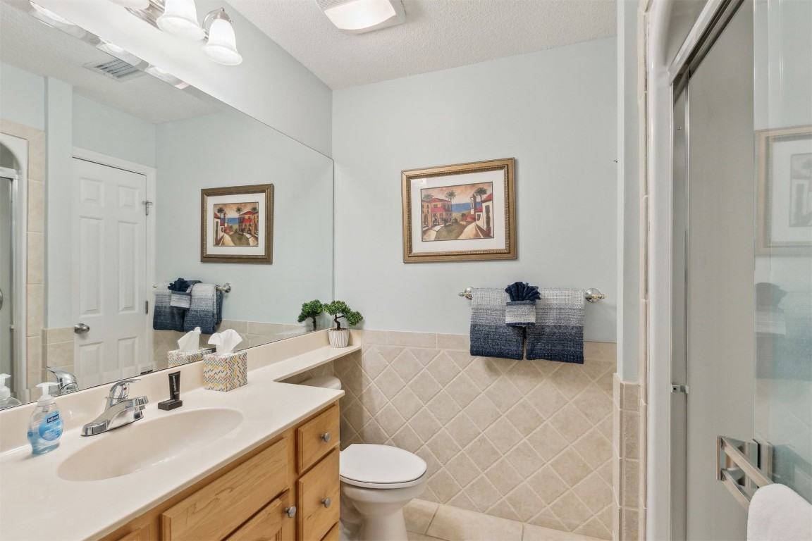 3323 Sea Marsh Road, Unit 3323 Fernandina Beach, FL 32034 - Photo 19 of 48 a bathroom with a toilet a sink and a mirror