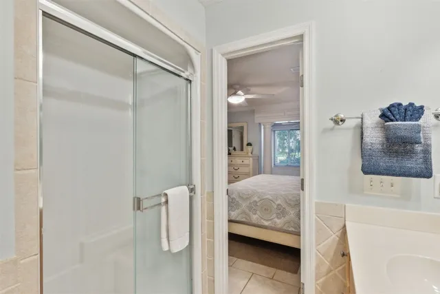 a en suite bathroom with a granite countertop sink and a mirror