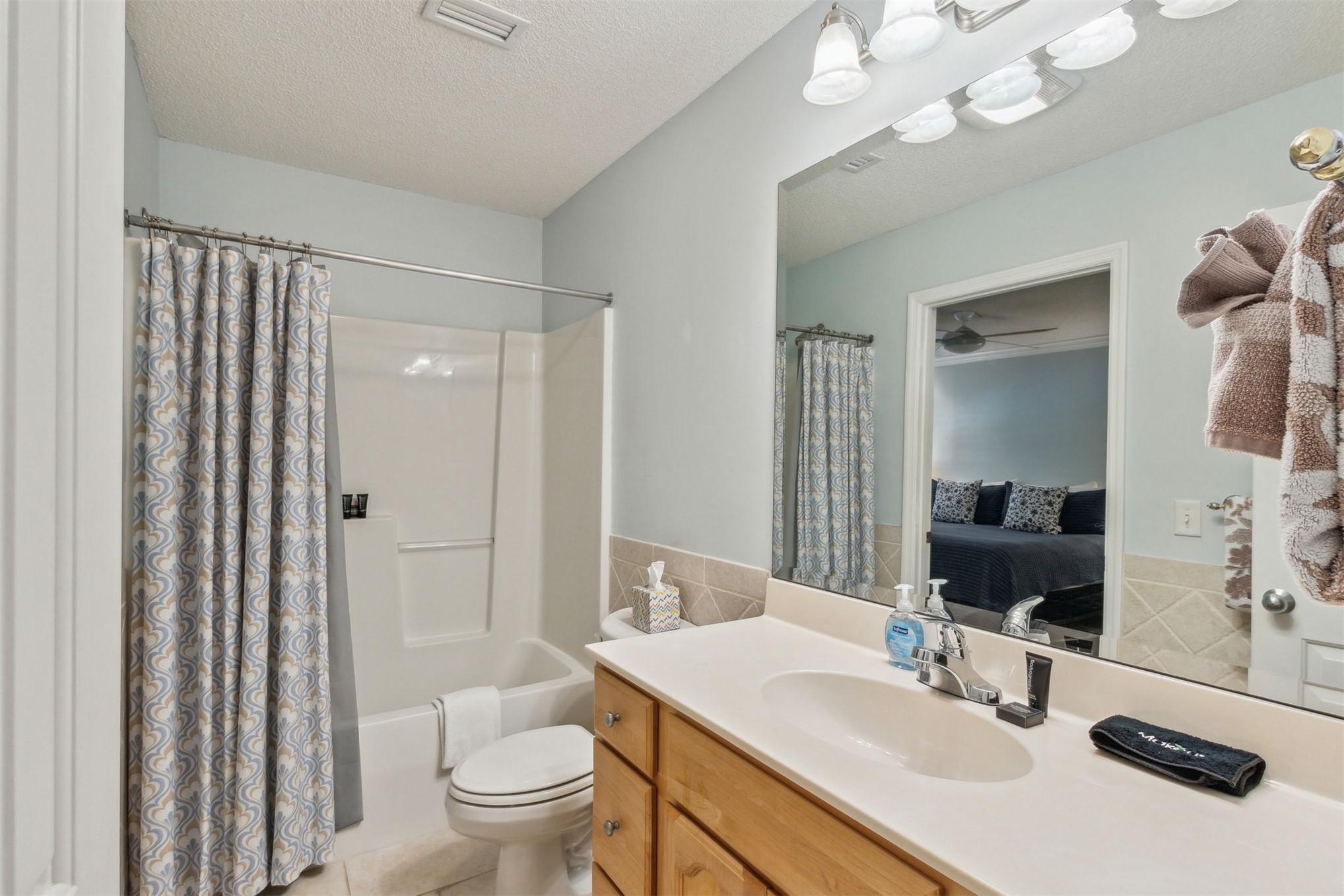 3323 Sea Marsh Road, Unit 3323 Fernandina Beach, FL 32034 - Photo 21 of 47 a bathroom with a sink a toilet and a large mirror