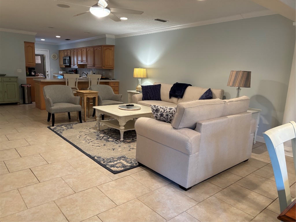 3323 Sea Marsh Road, Unit 3323 Fernandina Beach, FL 32034 - Photo 3 of 48 a living room with furniture and a dining table with kitchen view