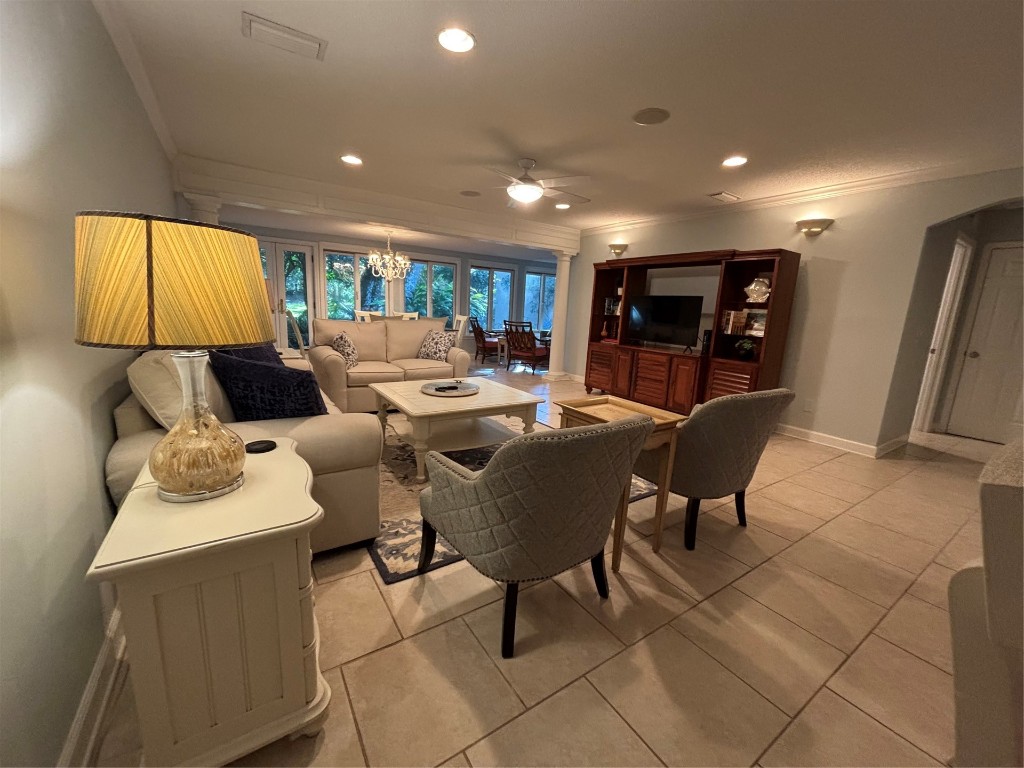 3323 Sea Marsh Road, Unit 3323 Fernandina Beach, FL 32034 - Photo 4 of 48 a living room with furniture a flat screen tv and a large window
