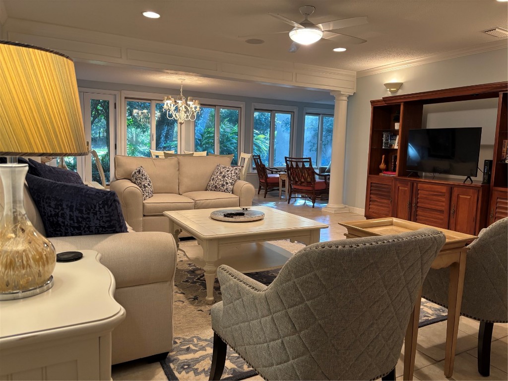 3323 Sea Marsh Road, Unit 3323 Fernandina Beach, FL 32034 - Photo 5 of 48 a living room with furniture a flat screen tv and a large window