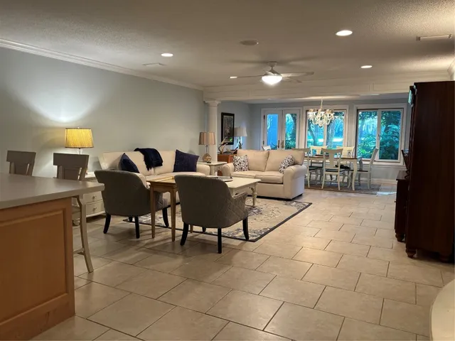 a living room with furniture a large window and a fireplace