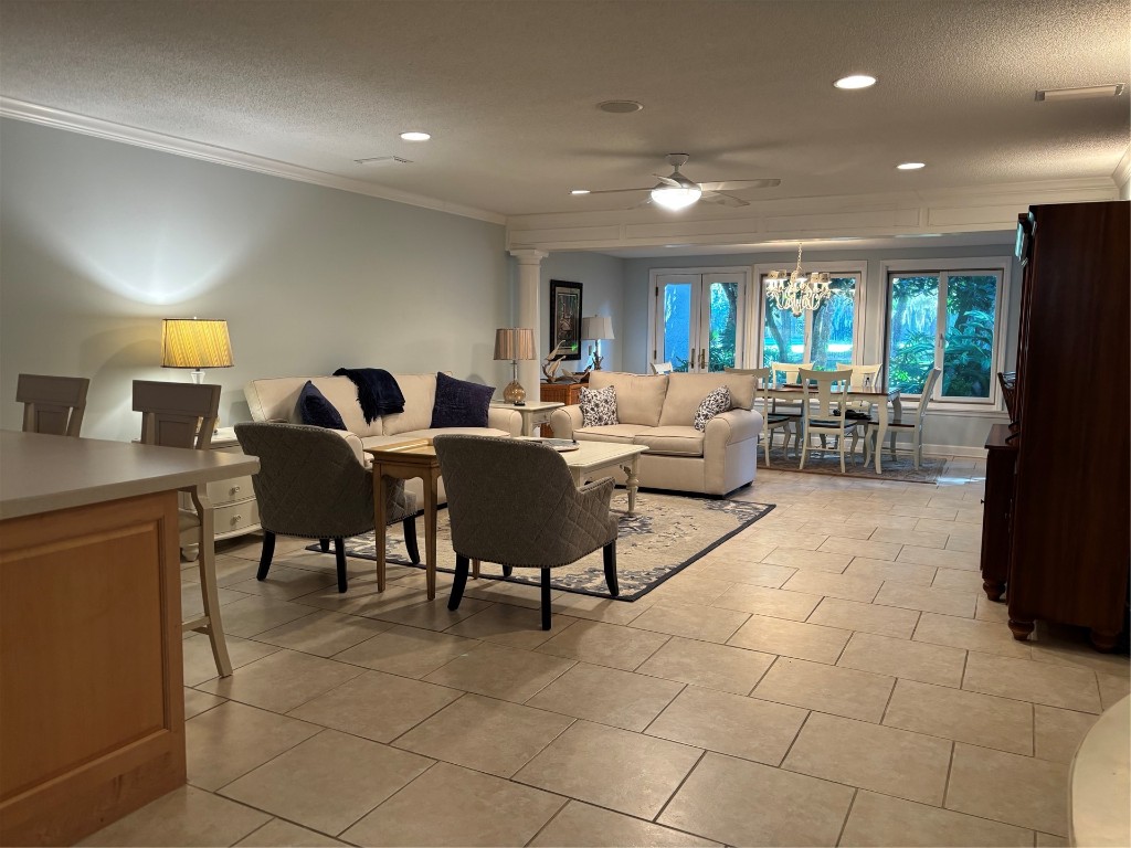 3323 Sea Marsh Road, Unit 3323 Fernandina Beach, FL 32034 - Photo 7 of 48 a living room with furniture a large window and a fireplace