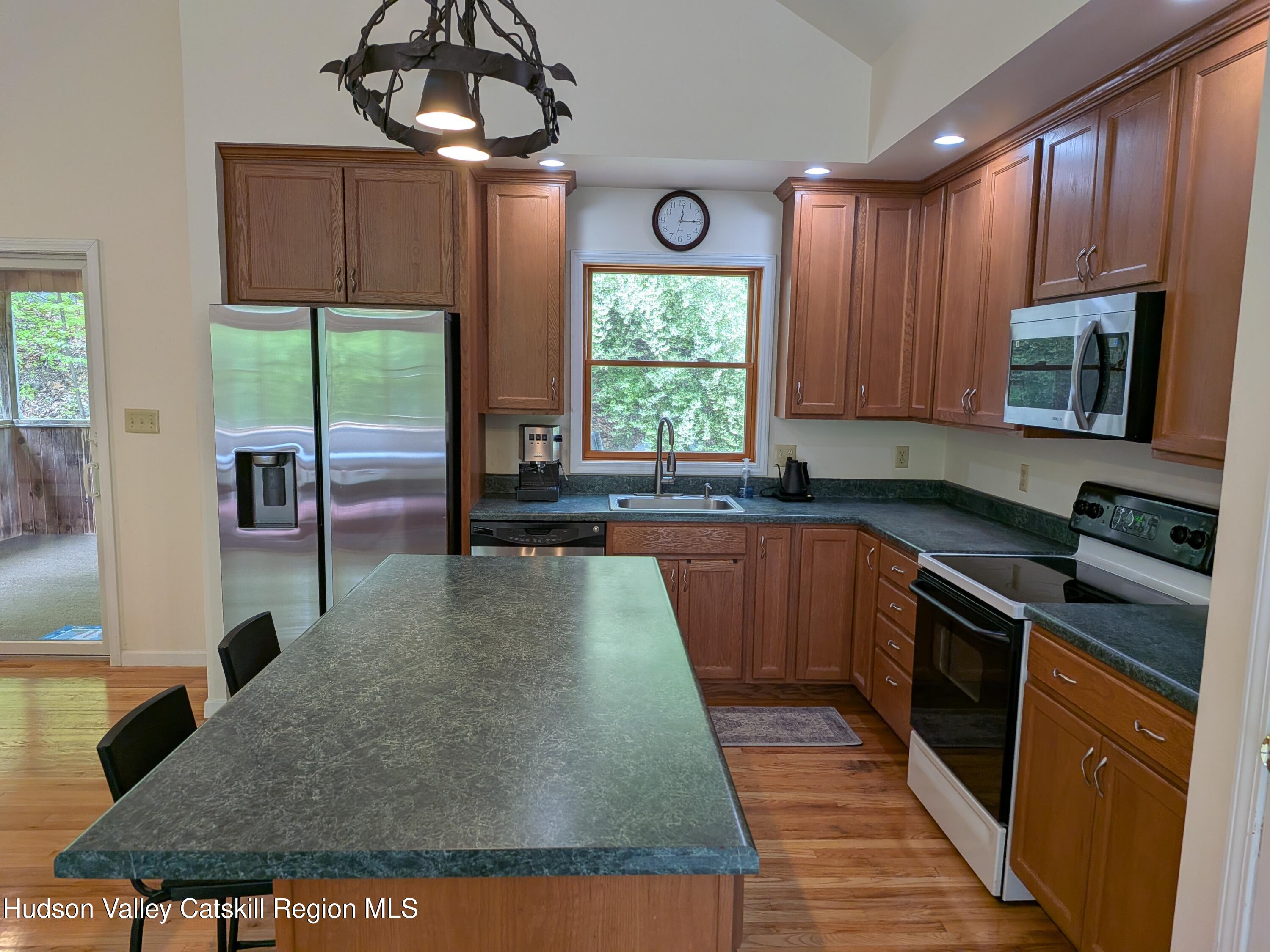 513 South Mountain Road Gardiner, NY 12525 - Photo 14 of 63 a kitchen with kitchen island granite countertop a sink a counter top space appliances and cabinets