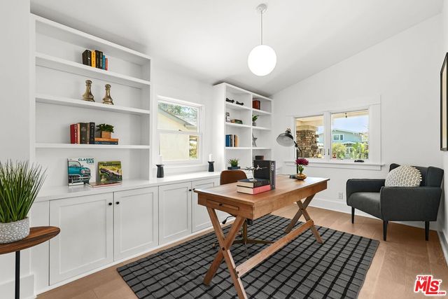a view of a livingroom with furniture and a bookshelf