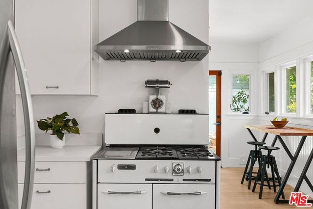 a white stove top oven sitting inside of a kitchen