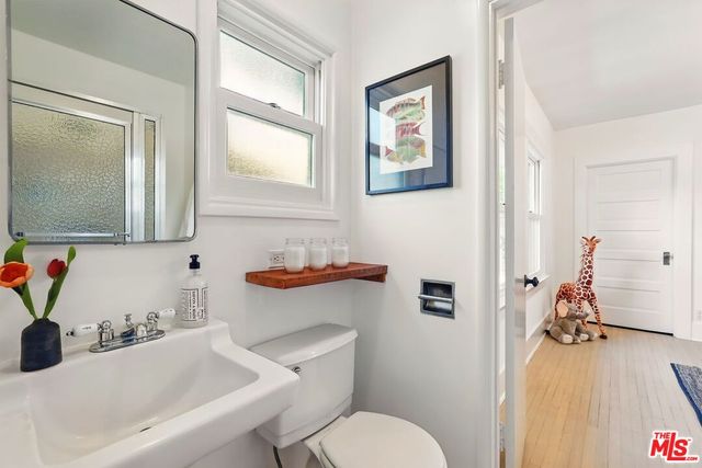 a bathroom with a sink toilet and mirror