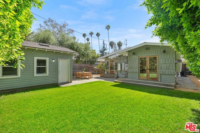 a backyard of a house with table and chairs