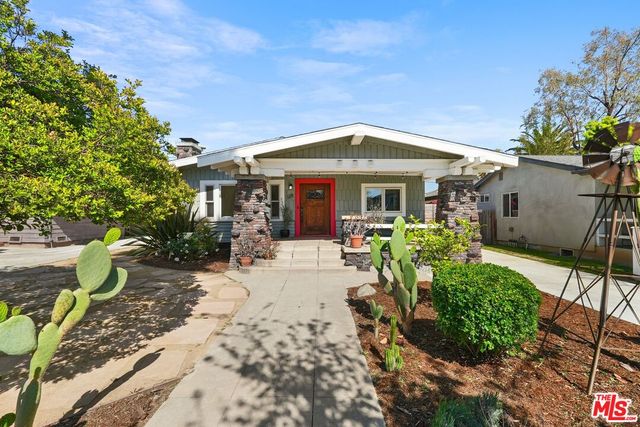 a patio with a table and chairs under an umbrella
